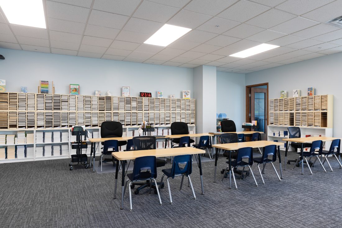Early learners room with child-height tables and picture books at our center
